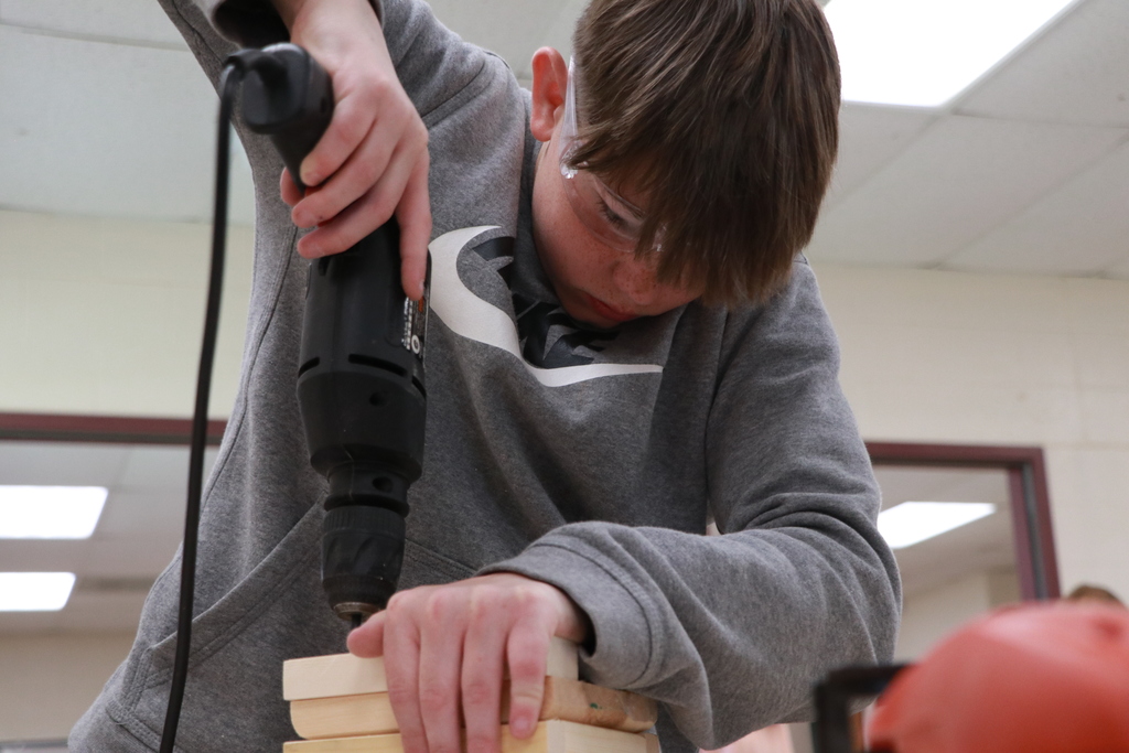 Student drills wood