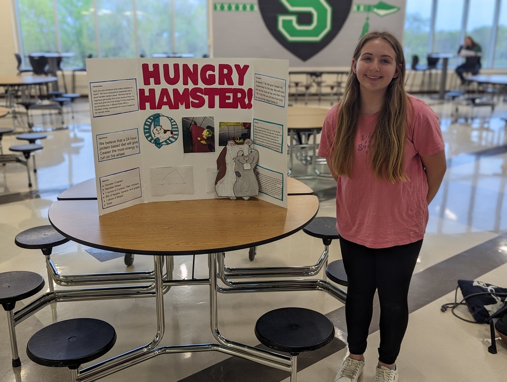 Student poses with Hungry Hamster Display