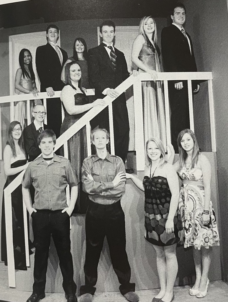 13 people along a set staircase